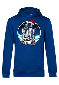 Blå hoodie med ett tryckt R2-D2-motiv med tomteluva mot en cirkulär bakgrund som framhäver snö och stjärnor. Mjuk bomullsmaterial.
