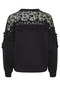Sweatshirt noir avec un dos en dentelle texturée présentant des broderies florales et une garniture décorative. Col rond et manches amples.