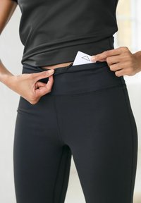 Next RIBBED YOGA - Leggingek - black kickflare