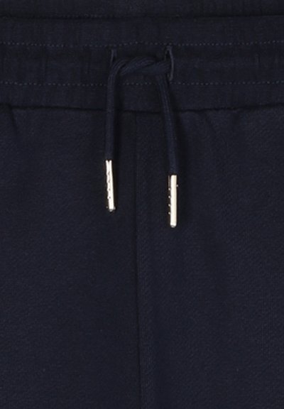 Pantalons de jogging bleu marine avec taille élastique et cordon de serrage agrémenté de détails dorés. Tissu doux au toucher lisse, idéal pour un look décontracté.