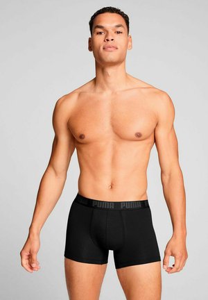 Black boxer briefs made of soft fabric, featuring a branded elastic waistband with 'PUMA' logo, and a fitted design.