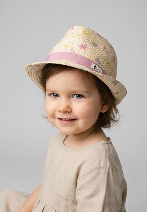 Toddler with blue eyes and brown hair wearing a beige dress and a floral-patterned straw hat with a pink band, smiling softly.