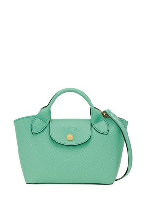 Small turquoise textured handbag with top handles, flap closure with gold button, and detachable strap on white background.