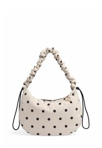 Beige polka dot taske i nylon med en skrumpet håndtag og en sort justerbar rem. Rund form med lynlåslukning.