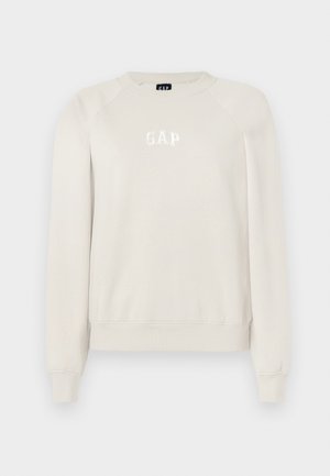 Lys beige sweatshirt laget av myk stoff, med rund hals, raglanermer, og "GAP"-logo i hvitt, samt ribbet liv og ermer.
