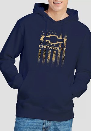 Navy blue hoodie featuring a gold Chevrolet logo and a design resembling a flag with stars and a camo pattern on the lower half.