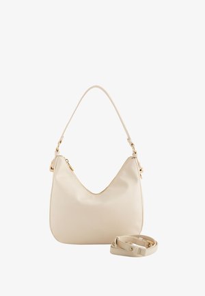 Crème-kleurige schoudertas van soepel leer, met een gebogen vorm, gouden hardware-accenten en een afneembare bijpassende schouderband.