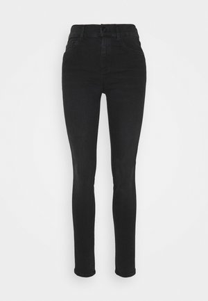 Vaqueros negros ajustados de cintura alta con bolsillos delanteros y cierre de botón, exhibidos sobre un fondo claro y sencillo.