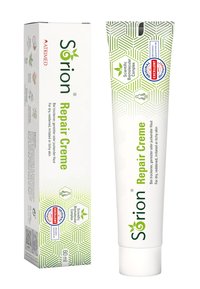 Sørion Repair Creme in a white tube with green accents and geometric patterns. Packaging features herbal imagery and labels for dermatological certification.