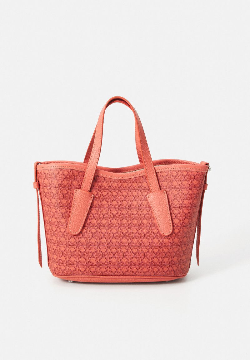 Coral tote bag with textured pattern, dual handles, and zip closure. Made from leather-like material, featuring a structured shape and smooth finish.