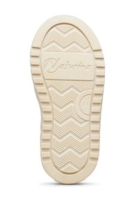 Suola di gomma crema con un motivo a zigzag, caratterizzata da un emblema circolare e il nome del marchio "Naturino" impresso.