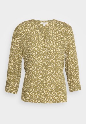 Groene V-hals blouse met witte bloemenprint, lange mouwen en knopen aan de voorkant.