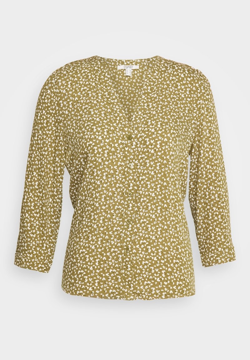 Blouse verte à col en V avec imprimé floral blanc, manches longues et boutons sur le devant.