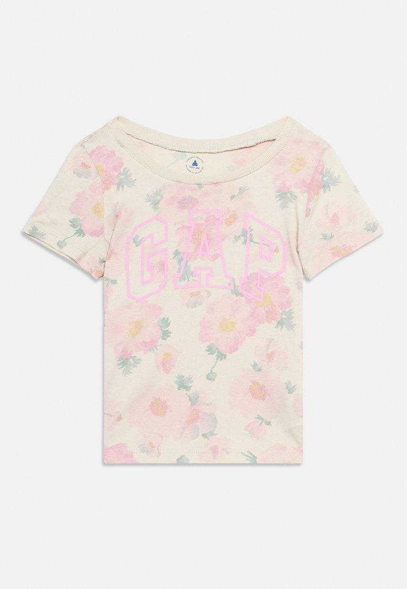 Κοντομάνικο κρεμ παιδικό μπλουζάκι με ροζ και κίτρινο ανθικό σχέδιο και μεγάλο ροζ περίγραμμα με το λογότυπο "GAP" στο μπροστινό μέρος.