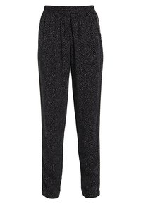 Czarne spodnie z elastycznym paskiem, zdobione rozrzuconym białym wzorem w kropki. Wykonane z miękkiego materiału, zwężające się w okolicy kostek, z bocznymi kieszeniami.
