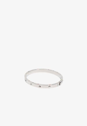 Silver metal bangle with a smooth finish, featuring subtle engraved numbers and four small clear stones embedded along the band.