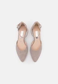 Escarpins à bout pointu en suède gris clair avec une sangle à la cheville et une boucle en argent. Texture lisse et design minimaliste.