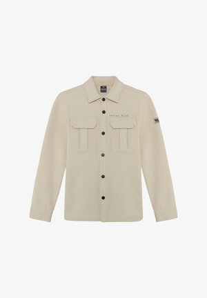 Beige jas met lange mouwen, knoopsluiting aan de voorkant, twee borstzakken en een merklabel. Heeft donkere knopen en gestructureerde borstzakken.