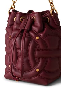 Burgundy leather bucket bag with gold hardware, drawstring closure, and quilted circular pattern. Soft texture and rounded shape.