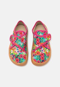 Colorful floral-patterned shoes with a canvas upper, pink accents, and a rubber sole. Feature a cross strap closure design.