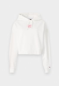 Haut à capuche court blanc avec un logo en cœur rose sur la poitrine, manches longues et capuche avec cordon de serrage ajustable. Tissu doux et poignets côtelés.