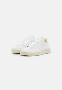 Hvite lær sneakers med teksturert overflate, med avrundet tå, snøring og beighgummi såle.