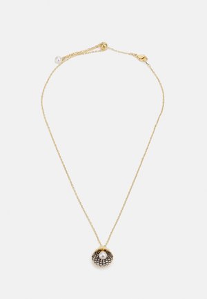 Gold chain necklace featuring a shell-shaped pendant with a central pearl and crystal accents. Delicate and textured design.