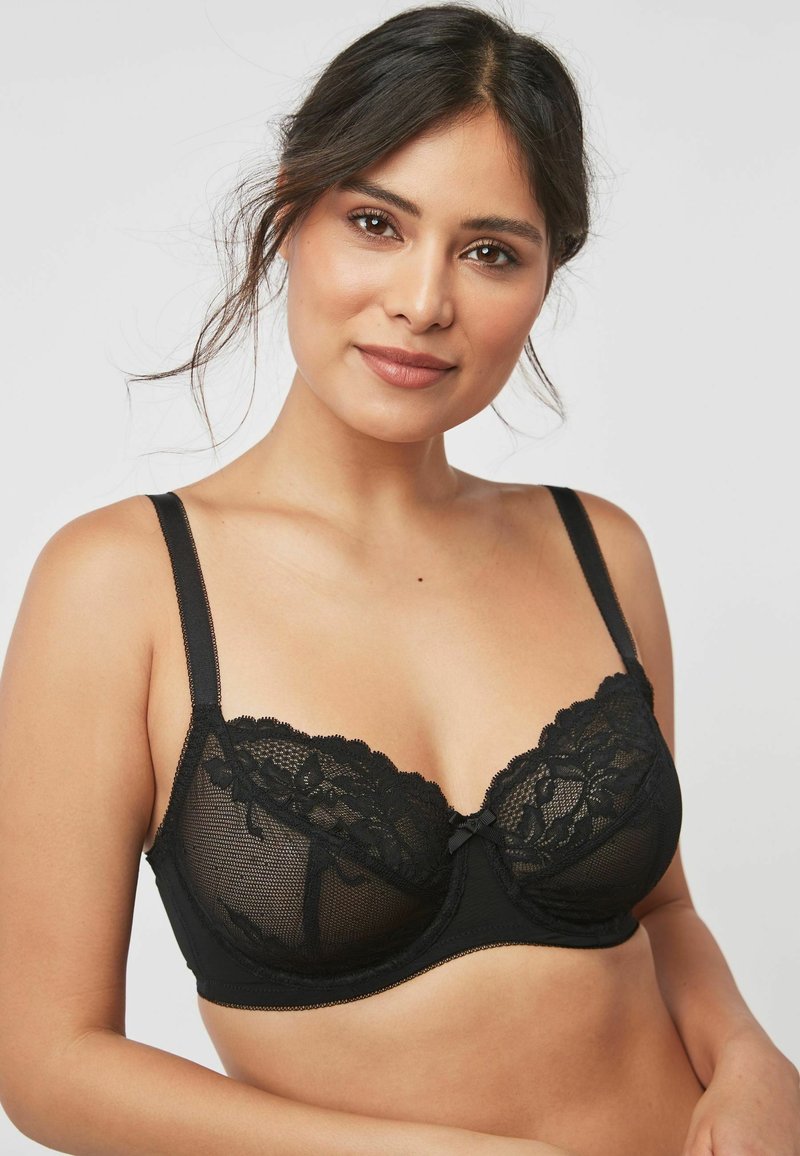 Svart bh med en genomskinlig meshdesign och blomster-lace detaljer, med underwire stöd, justerbara band och en liten central rosett.