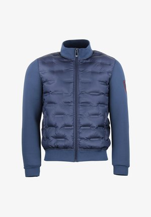 Veste matelassée marine avec fermeture éclair, présentant un devant matelassé, des manches longues lisses et des poignets côtelés. Comprend un petit détail de logo sur la manche.