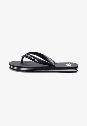 Zwarte flip-flops met een gestructureerde rubberen zool, dunne band en witte accenten langs de randen. "Quiksilver" logo zichtbaar op de band.