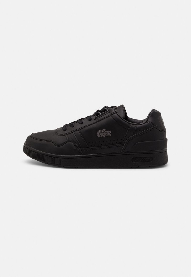 Black leather sneaker with lace-up design, perforated accents on the side, and a textured rubber sole. Features a subtle logo near the heel.