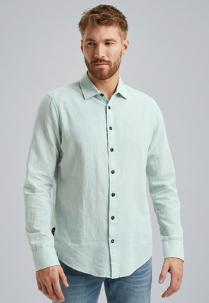 Helles mintgrünes Langarmhemd aus Leinenstoff, mit schwarzen Knöpfen, einem spitzen Kragen und abgerundetem Saum. Lässiges Design, lockere Passform.