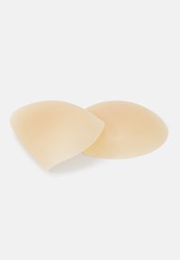 Silicone breast pads in a soft beige color, featuring a smooth texture and curved shape to provide natural contour and support.