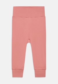 Leggings de color rosa claro, fabricados con un tejido suave y elástico, con una amplia cinturilla elástica y puños ajustados en los tobillos. Diseño sencillo y en un solo color.