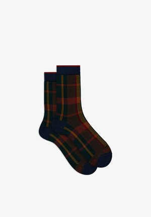 Calzini decorati con motivo scozzese in verde scuro, rosso e giallo con bordo e punta blu navy. Realizzati in tessuto elastico.