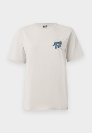 Kortermet beige bomulls t-skjorte med en blå grafikk "Santa Cruz" logo på venstre brystområde. Jevn tekstur. Rund hals.