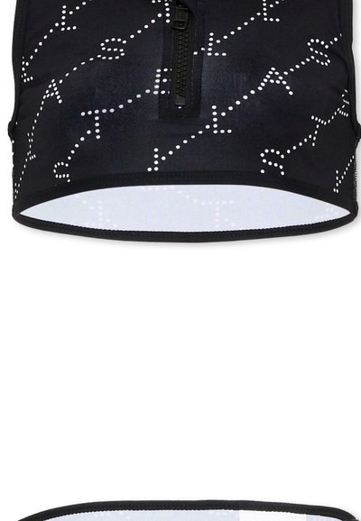 Brassière de sport noire avec motif abstrait à points blancs et fermeture éclair avant, vues de face et du dessous.