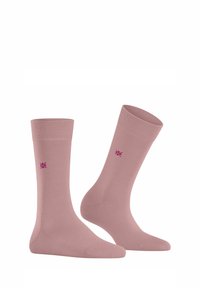 Calzini di cotone rosa chiaro con bordo a coste e texture liscia, caratterizzati da un piccolo motivo floreale viola alla caviglia.