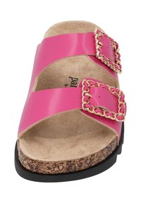 Pink sandals with two wide straps, featuring gold chain accents. Cork footbed and black rubber sole provide contrast in material and texture.