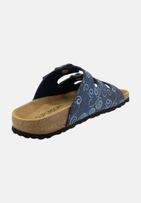 Navy slide sandal with swirl pattern in light blue, adjustable straps, cork midsole, and black textured rubber outsole.
