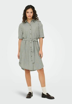 Striped shirt dress in green and gray, button-front with short sleeves, tied belt at waist, knee-length hem, paired with dark loafers and white socks.