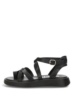 Sandalia negra plana con suela gruesa, correas de cuero entrecruzadas y hebilla ajustable en el tobillo, vista lateral.