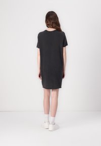 Charcoal gray t-shirt dress with short sleeves, rounded neckline, and relaxed fit. Soft fabric drapes to mid-thigh. Simple, clean design.