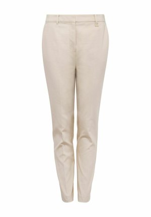 Beżowe dopasowane spodnie o gładkiej fakturze, wąskim kroju i standardowym pasie. Posiadają przednie kieszenie oraz subtelne detale przeszycia.