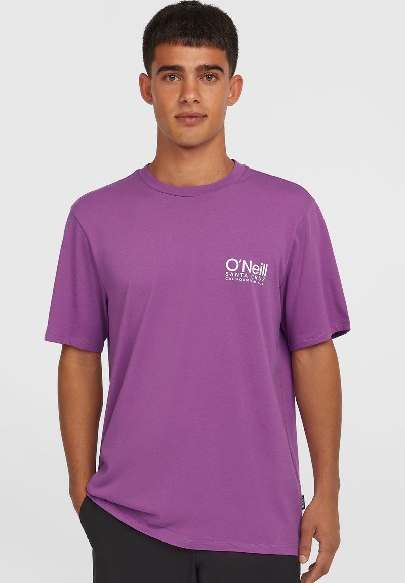 Short sleeve, crew neck t-shirt in vibrant purple. Made of cotton blend, features a small white logo on the left chest. Clean design.