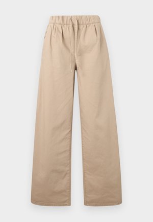 Bež široke hlače s elastičnim pojasom i vrpcom za vezanje, izrađene od glatkog materijala, prikazane na jednobojnoj svijetloj pozadini.