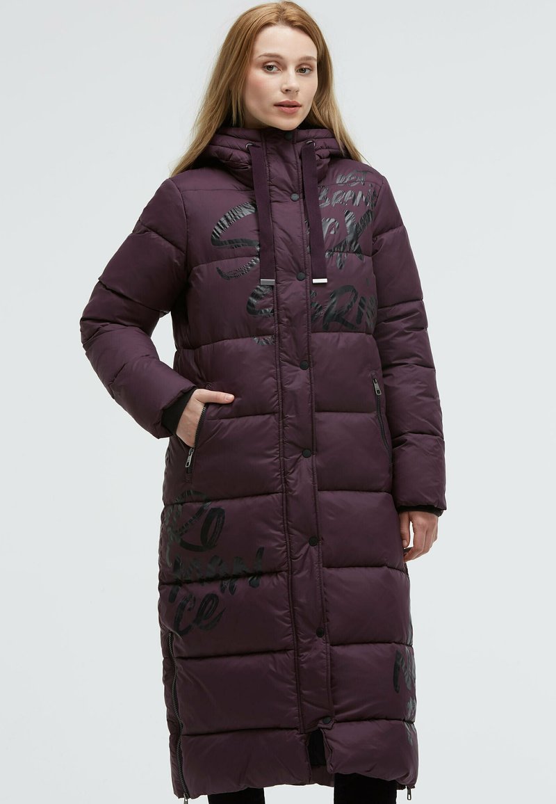 Long purple puffer coat with quilted design, black printed text accents, hood, and zippered pockets. Smooth, shiny texture.
