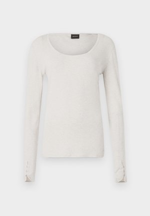 Heled pikad käised helesinised T-särk pehmest puuvillast, millel on ümmargune kaelus ja nööbid randmetel. Lihtne ja minimalistlik disain.