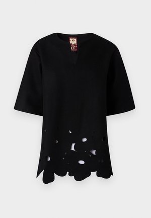 Black top with a V-neck and short sleeves. Features a unique cut-out floral pattern along the hem, made from textured fabric.