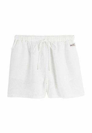 Weiße Leinen-Shorts mit Kordelzug, elastischem Bund und kleinem braunen Schriftzug „self.“ auf der rechten Seite nahe der Taille.